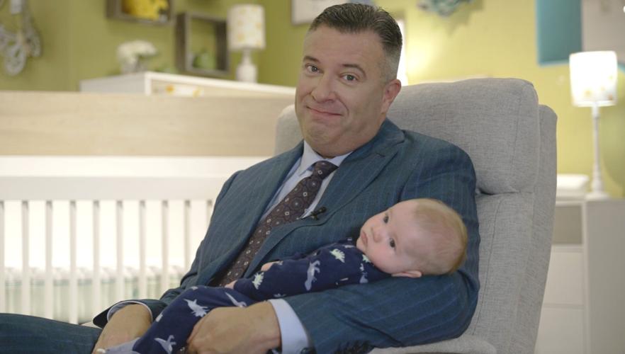 Darvin Furniture & Mattress President, Will Harris, with a young fan in the showroom's extensive Baby Gallery.