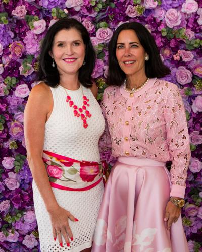 WINGS CEO Rebecca Darr (L) thanks Host Committee member Renee Zipprich for creating and donating all the floral arrangements for the luncheon.