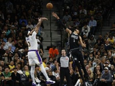 Anthony Davis of the Los Angeles Lakers, left, shoots over San Antonio's Victor Wembanyama in the Lakers' 120-115 victory over the Spurs