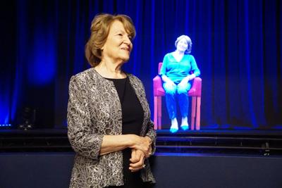 The late Fritzie Fritzshall in front of her hologram in Illinois Holocaust Museum's Survivor Stories exhibit.