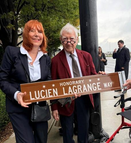 Architect Lucien Lagrange, shown with wife Melinda Jakovich-Lagrange, was honored with "Honorary Lucien Lagrange Way" in Streeterville on Sept. 19, with Alderman Brian Hopkins presenting the sign before a crowd of friends, fans and admirers. (Frank Jeff...