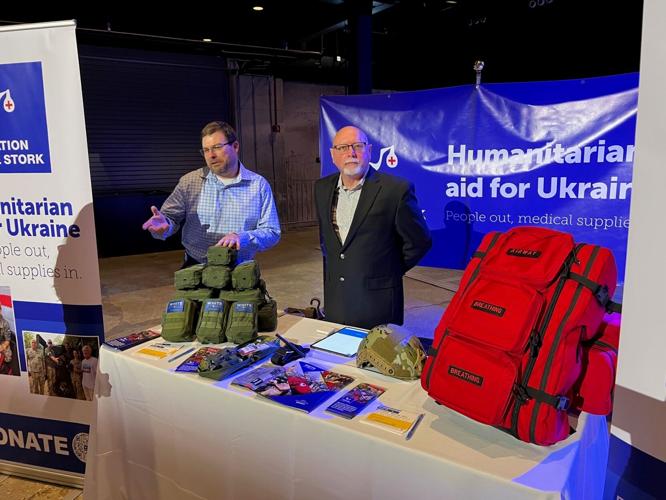 U.S. Marine veterans man booth to discuss individual first aid kits distributed by White Stork to the soldiers on the front lines of war in Ukraine.