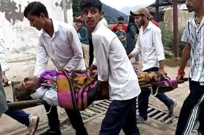 Crowds gathered at a Kishtwar hospital in Indian-administered Kashmir while people carried some of the injured on stretchers