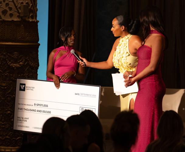Salt & Light Coalition "Thriver", Audrina Sinclair presents check to B-Spotless, one of the many nonprofits the organization supports. (Photo by Lilia Crader)