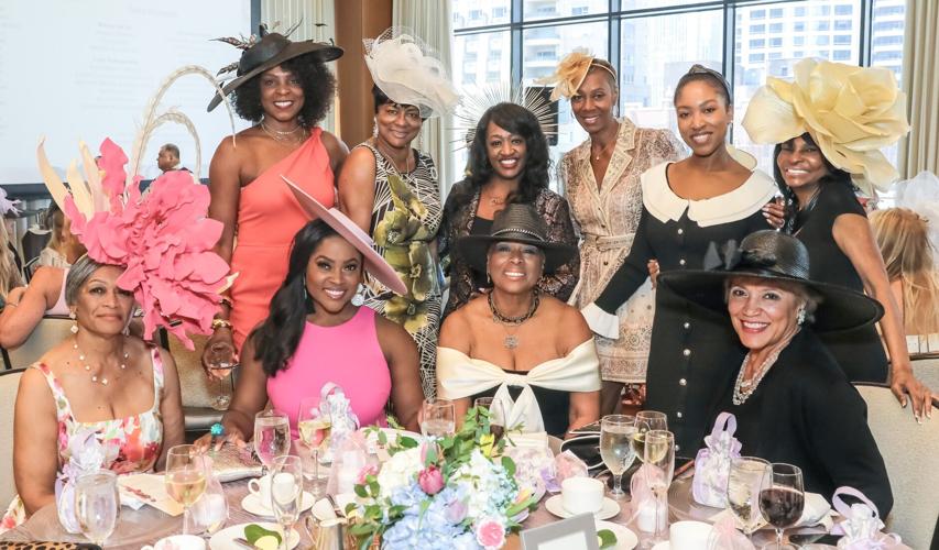 Belvon Walker (L), winner of one of the Best Hat Awards, with a table of beautiful friends. (Photo by Mila Samokhina)