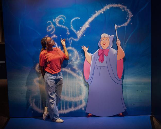Take an enchanting photo with the Fairy Godmother from Cinderella (1950) in the The Magic of Sound and Music gallery at Disney100: The Exhibition. (Photo courtesy of © Disney by Stephanie Ramones)