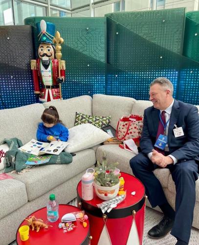 Darvin President Will Harris greets a young patient in the Lurie Children's Room, a newly transformed space within the hospital created by Darvin and Flexsteel.