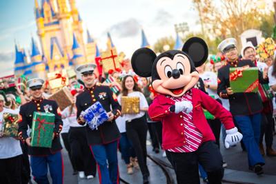 Mickey Mouse joins cast members and local Marines on Main Street, U.S.A. in Magic Kingdom for the finale celebration of his global giving journey. Photo Credit: Bennett Stoops