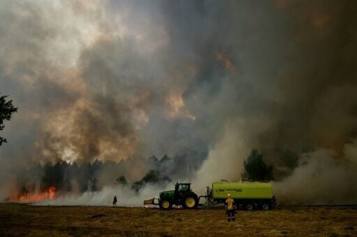 Firefighters use controlled blazes to create fire breaks to act as buffers near Bordeaux, in southwest France
