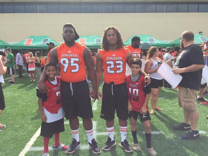 Nick Rodriguez stands with Miami players