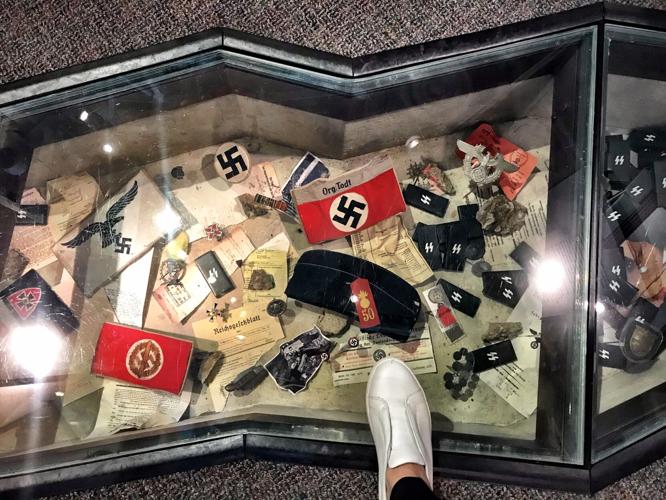 Walking on Nazi artifacts in an exhibit.