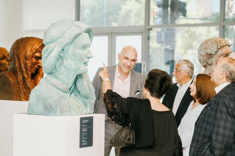Artist George Petrides (center) speaks with guests about Hellenic Heads at the National Hellenic Museum _ Image courtesy National Hellenic Museum.jpg