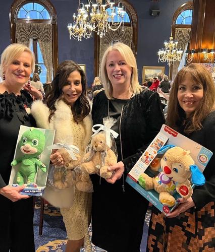 Kathy Piccone, Tracey Tarantino DiBuono, Tina Koegel and Wendy Krimins bring gifts to Service Club's Holiday Luncheon for kids of The Chicago Lighthouse.
