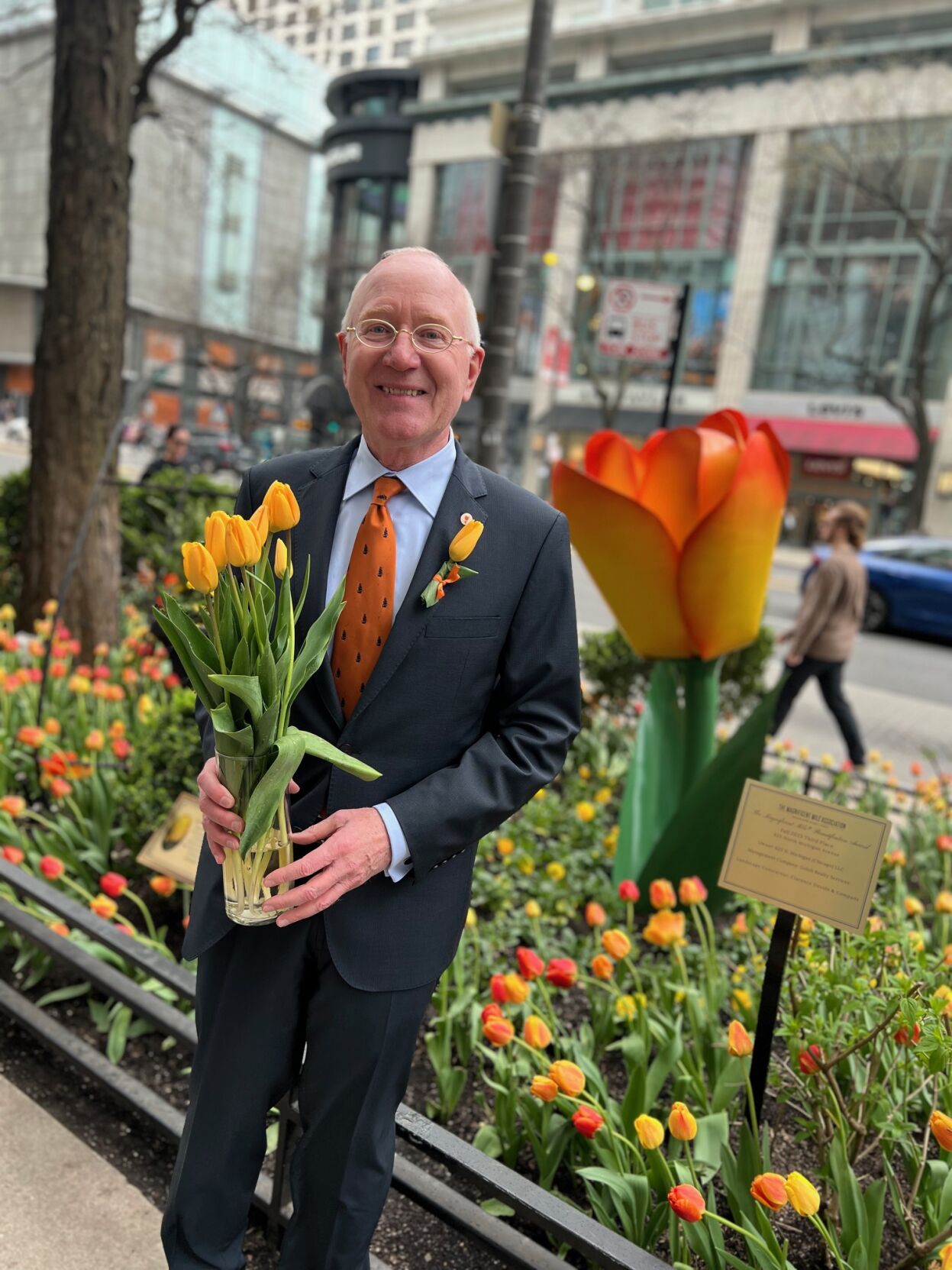 Bart Twaalfhoven, Consul General of the Kingdom of the Netherlands in Chicago, holds The Magnificent Mile Tulip, debuted on Michigan Avenue, April 17. (Photo | Candace Jordan)