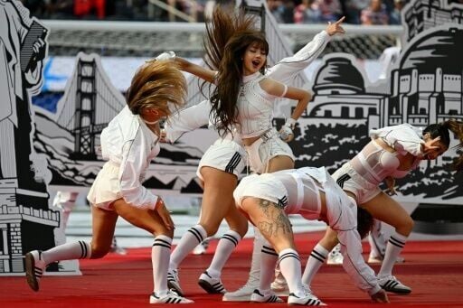 A marching band struck up the music before being joined by stars including K-pop singer Lisa