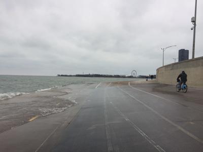 Lake Michigan waves lap the Lakeshore Path, a popular thoroughfare for cyclists 1