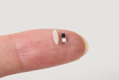 A tiny pacemaker, smaller than a grain of rice, sits on a fingertip. Designed at Northwestern University, it can be injected by syringe, eliminating surgery. (Photo: Northwestern University)