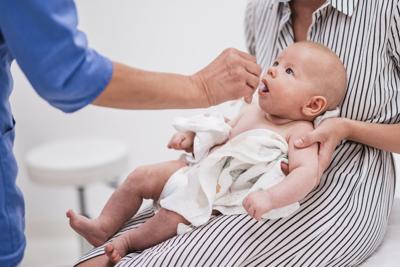 Pediatrician administering oral vaccination against rotavirus infection to baby. (Shutterstock photo)