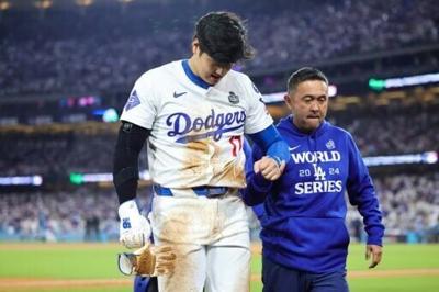 Shohei Ohtani leaves the field after injuring his shoulder in game two of the World Series on Saturday; the Japanese star was passed fit to play in Monday's game three