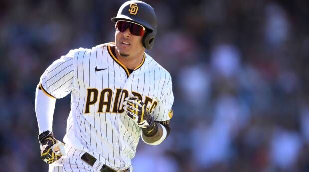 Dominican Republic third baseman Manny Machado, left, tags out