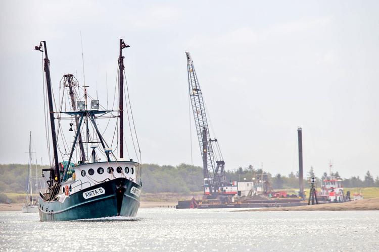 The F/V Anita D heads toward the Port of Ilwaco to offload as dredge work continues in the Ilwaco Channel in late August