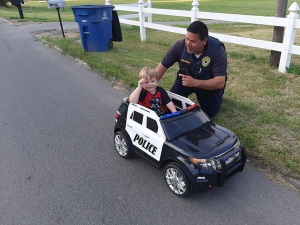 2 - Del Garcia with kid in police car