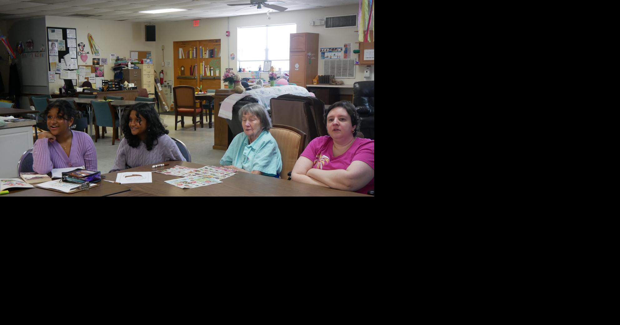 High school students volunteer with elderly with dementia