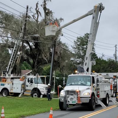energy company fixing power pole