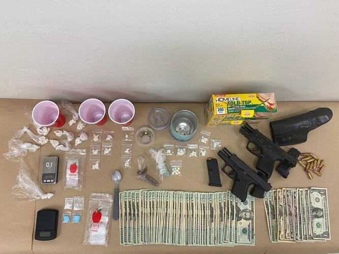 Two people arrested after search warrant leads to drugs, guns | Local ...