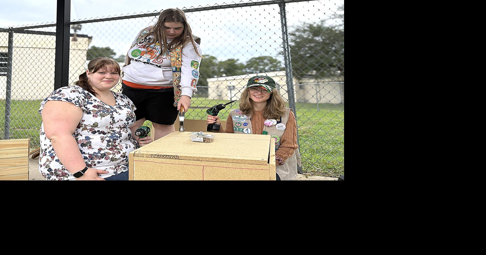 Girl Scouts serving God and community with hammers and drills
