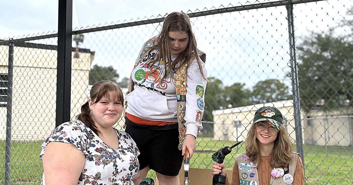 Girl Scouts serving God and community with hammers and drills