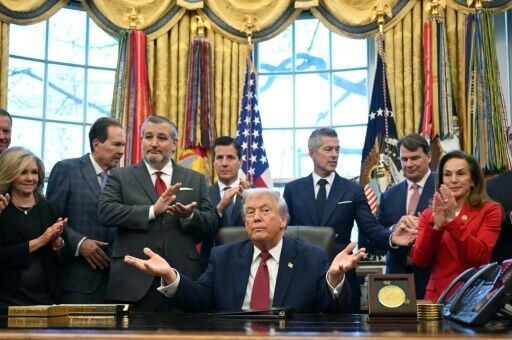 Trump was flanked in the Oval Office by the CEOs of Ford and Stellantis and a senior General Motors official, a show of buy-in from Detroit's &quot;Big Three.&quot;