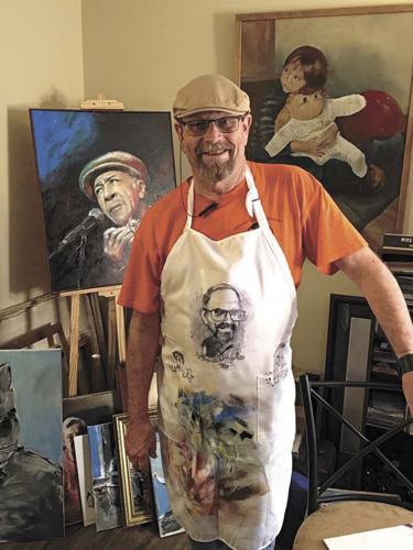 Special to Wink Magazine Mike Everidge in his studio, flanked by some of his art, including his portrait of Morristown-native Blues legend Wallace Coleman.