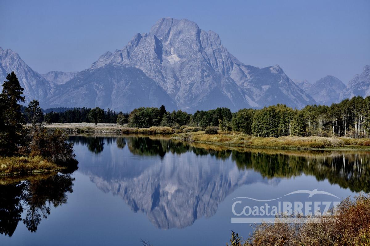 Dolphins_2. The Teton mountain range is reflected in a very calm Snake River..JPG
