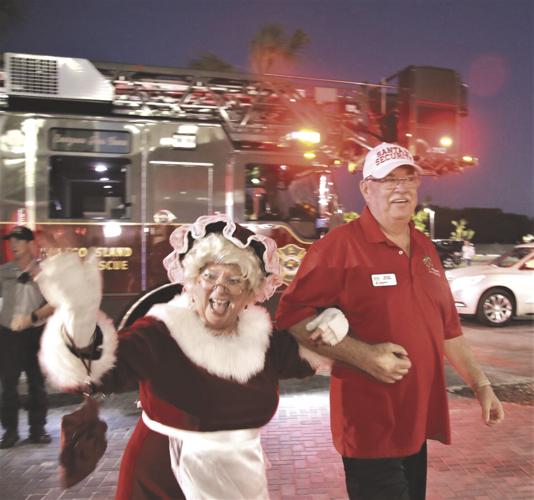 2. In 2021, Mrs. Claus came with her own Santa Security guard, Bob Drzal..tif