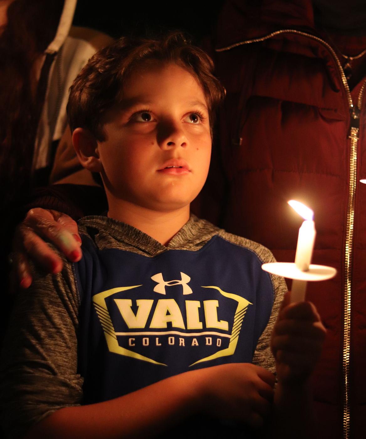 mourners light candles for meza news