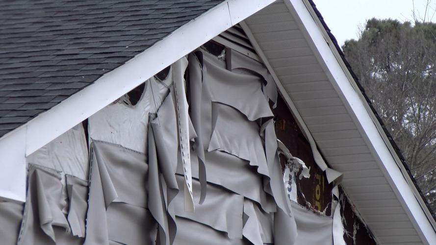 The siding on nearby homes was damaged from wind and heat.