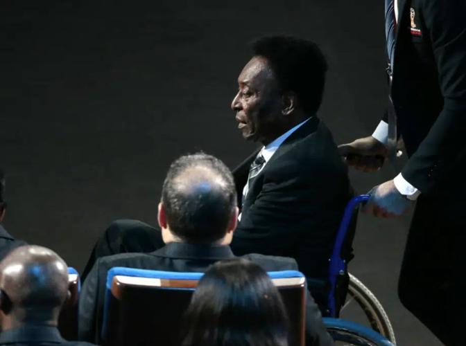 FILE - Brazilian soccer legend Pele is pushed in a wheelchair as he arrives at the 2018 World Cup soccer draw at the Kremlin in Moscow, Dec. 1, 2017. Pelé, the Brazilian king of soccer who won a record three World Cups and became one of the most command...