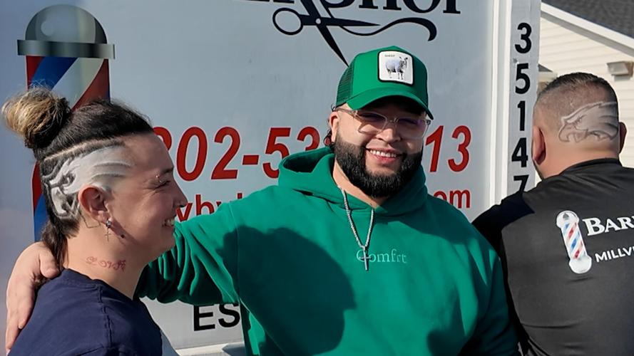 Jennifer Yates, Victor Hernandez and Paul Cusimano at Millville Barbershop with Eagles haircuts ahead of Super Bowl 59