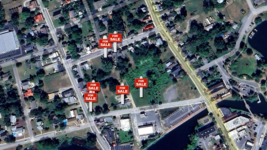 The properties include two homes in the historic district, one commercial lot, two residential lots, and one lot with an existing home.