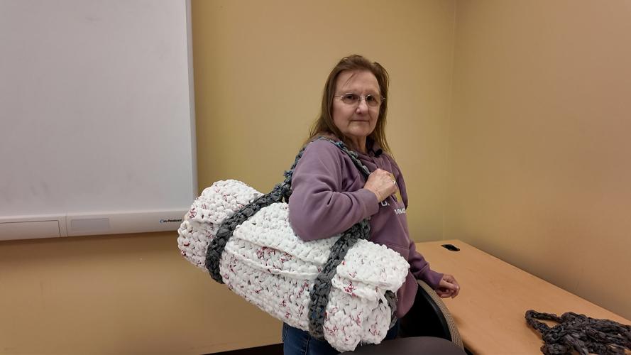 Linda Mason showing a sleeping bag created from plastic bags