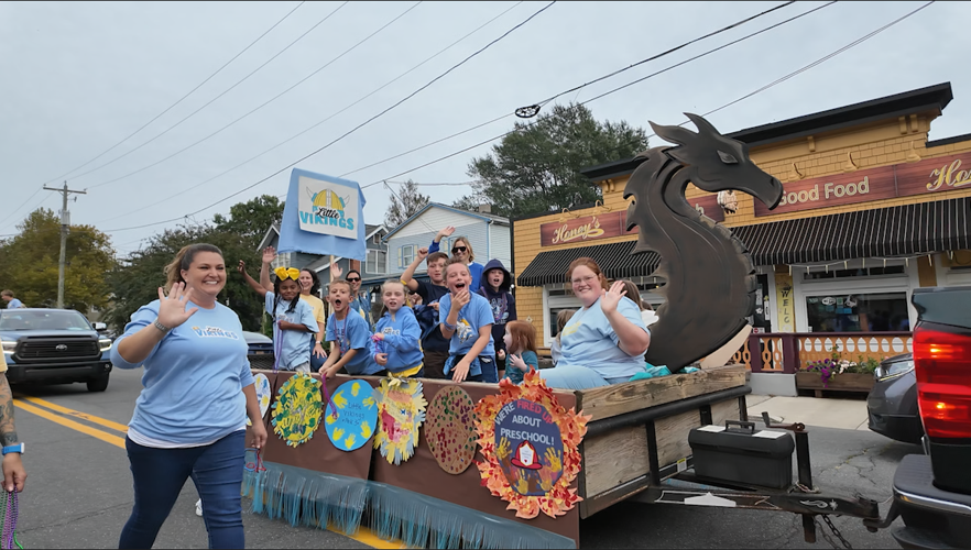 A parade float with children and adults.