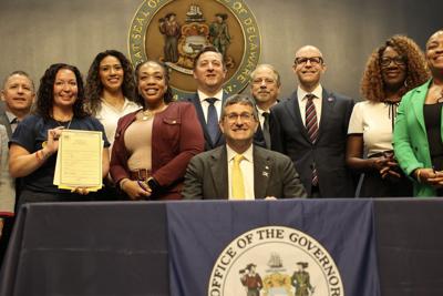 Lawmakers and advocates pose after SB22 is signed.