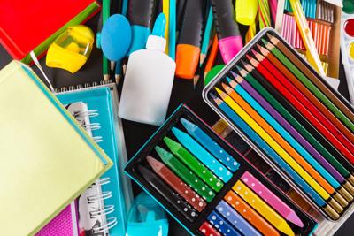 Photo of school supplies, pencils, and glue. 