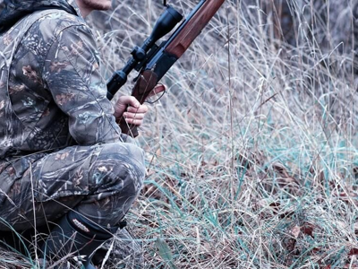 Man wearing camoflauge holding a gun
