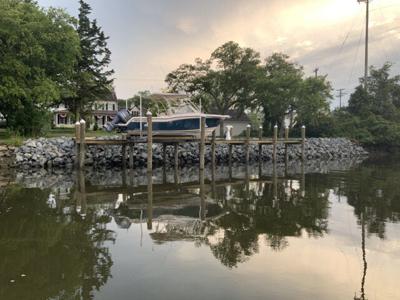 A boat on a dock above the water.