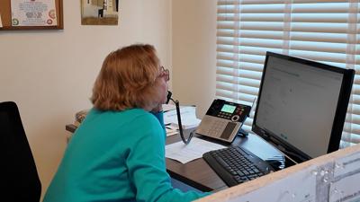 Volunteer on the phone at Village Volunteers in Lewes