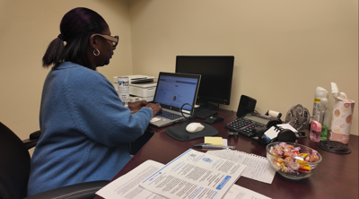 Photo of Karen Selby, a case manager with Love INC, works on her computer at the nonprofit's Georgetown office.