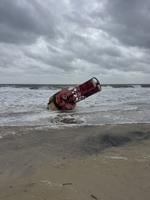 A red buoy washed up on the beach.