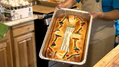 The Rosca de Reyes, adorned with crystallized dried fruits, red and green acitrons, and figs to symbolize the jewels in the Wise Men's crowns, contains hidden plastic figures of baby Jesus.